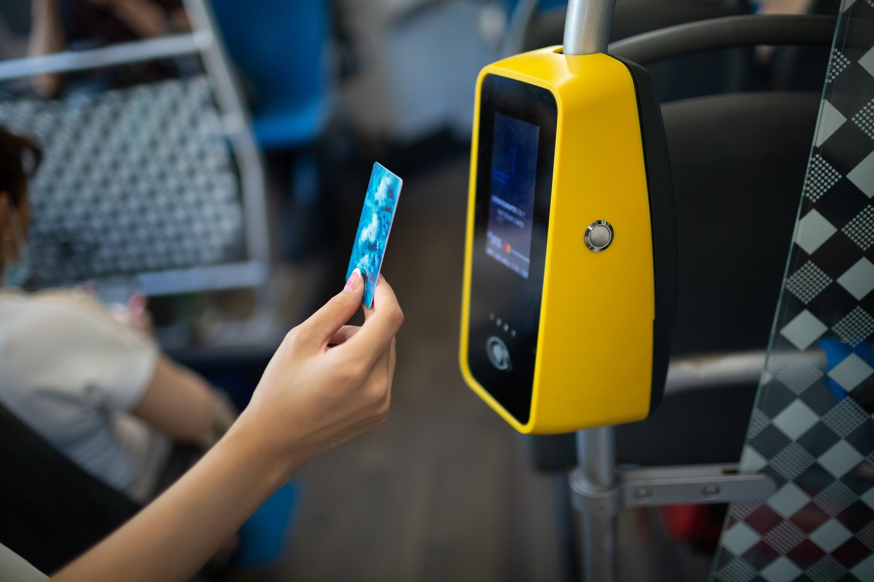 Asian Woman Paying Conctactless with Plastic Card for the Public Transport in Bus