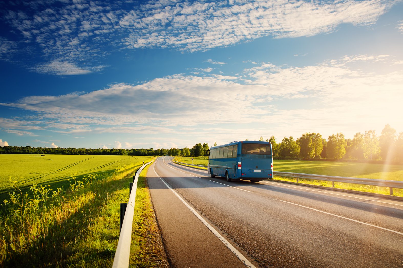 Bus on asphalt road in beautiful spring day